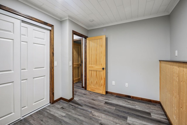 unfurnished bedroom with a closet, dark hardwood / wood-style floors, and ornamental molding