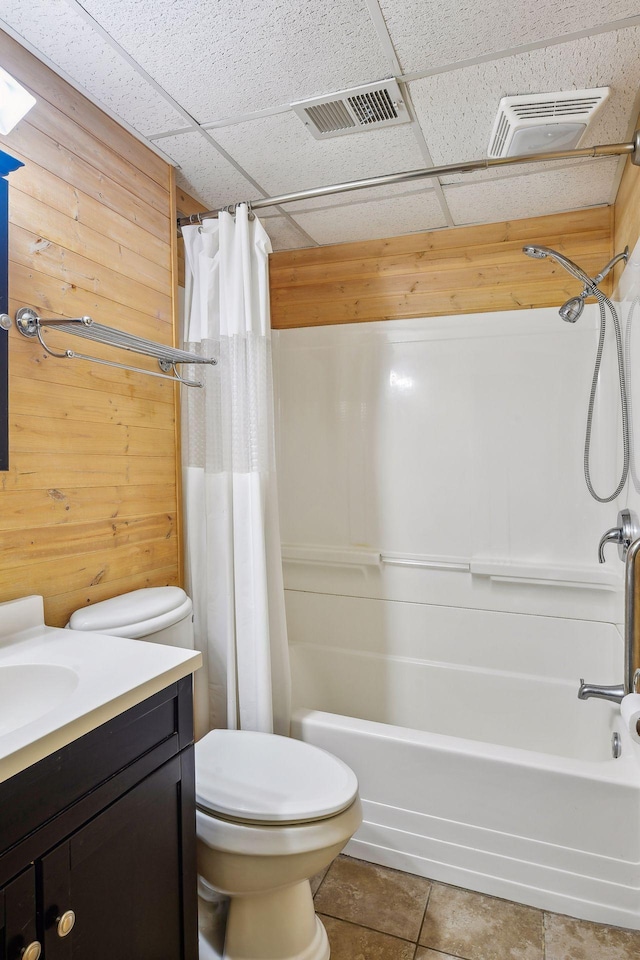 full bathroom with wooden walls, vanity, shower / tub combo with curtain, and toilet