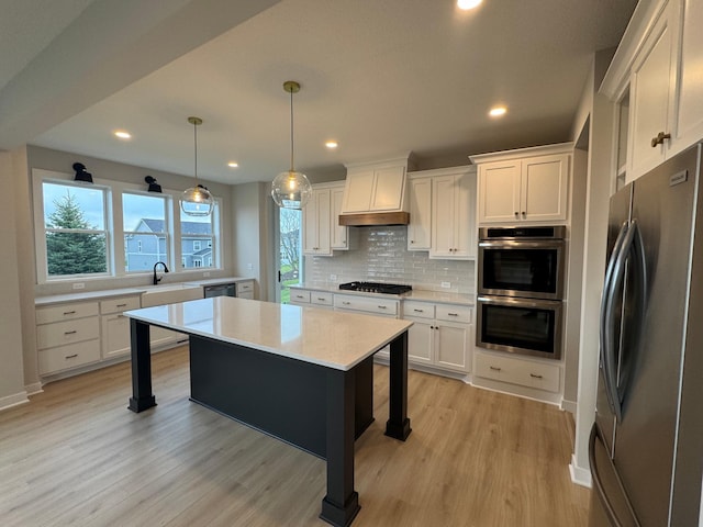 kitchen with appliances with stainless steel finishes, custom range hood, light countertops, decorative backsplash, and white cabinetry