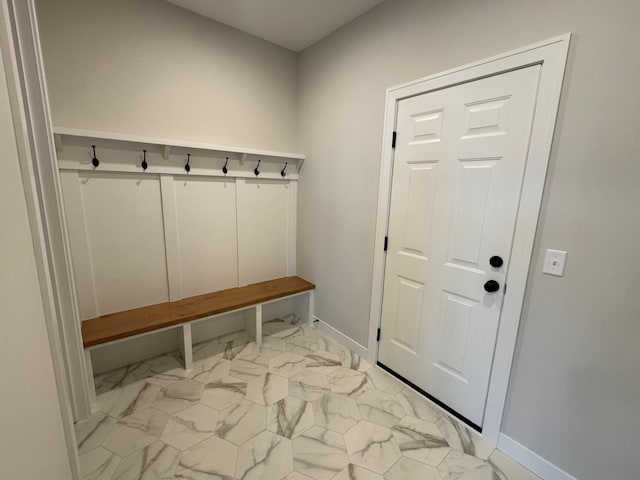 mudroom with light marble finish flooring and baseboards