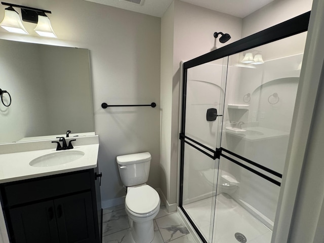bathroom with marble finish floors, a shower stall, toilet, vanity, and baseboards