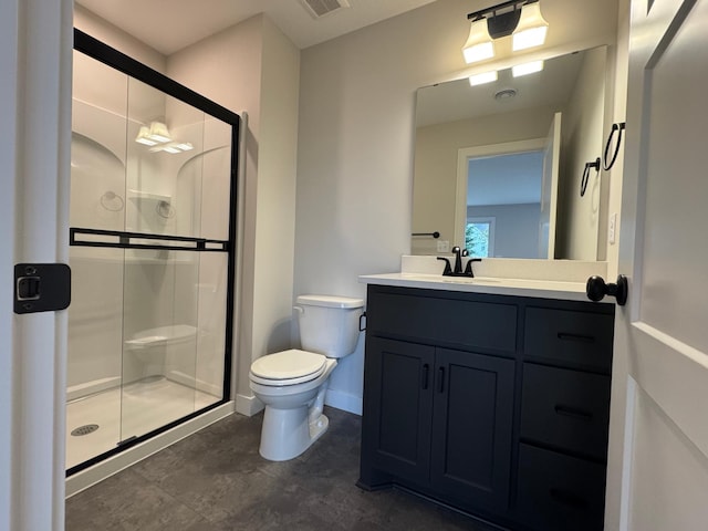 bathroom with a shower stall, toilet, vanity, and baseboards
