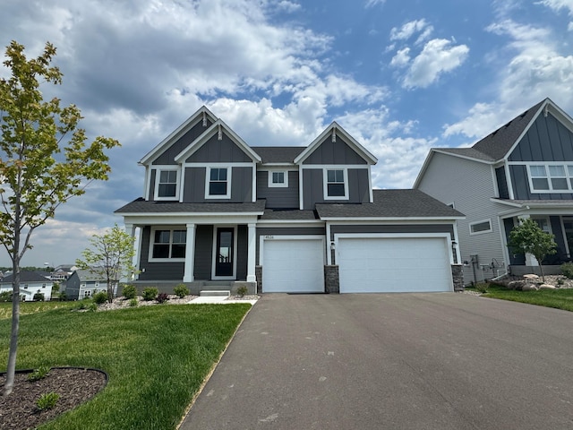 14526 Kingsview Ln N, Dayton, MN 55327 - craftsman-style home featuring driveway, a front yard, board and batten siding, covered porch, and an attached garage