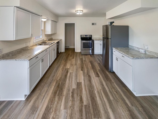 kitchen featuring sink, white cabinets, stainless steel appliances, and dark wood-type flooring