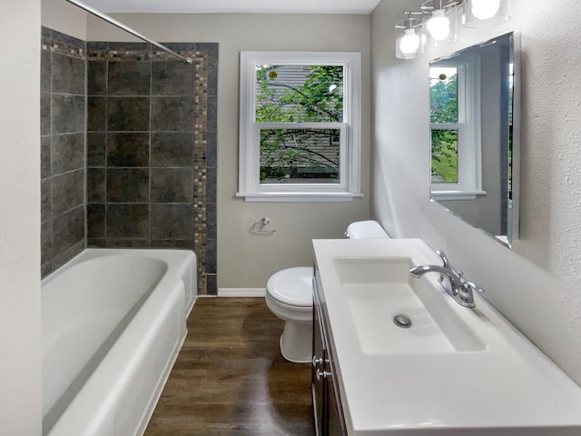 full bathroom featuring vanity, a wealth of natural light, toilet, and hardwood / wood-style floors