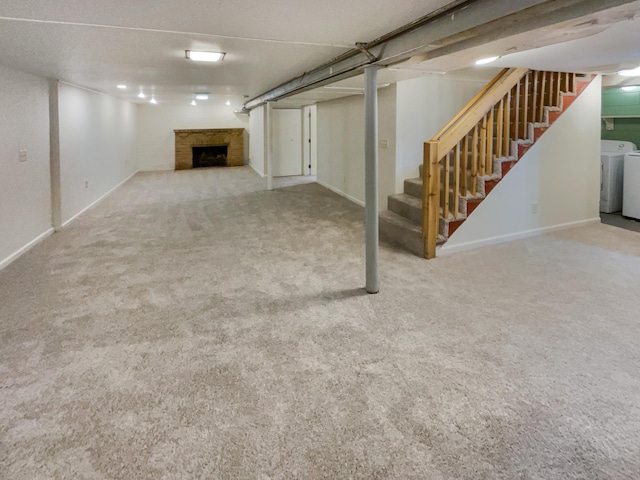 basement featuring washing machine and dryer and carpet floors