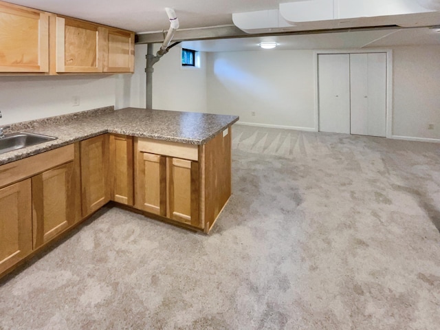 basement with sink and light colored carpet