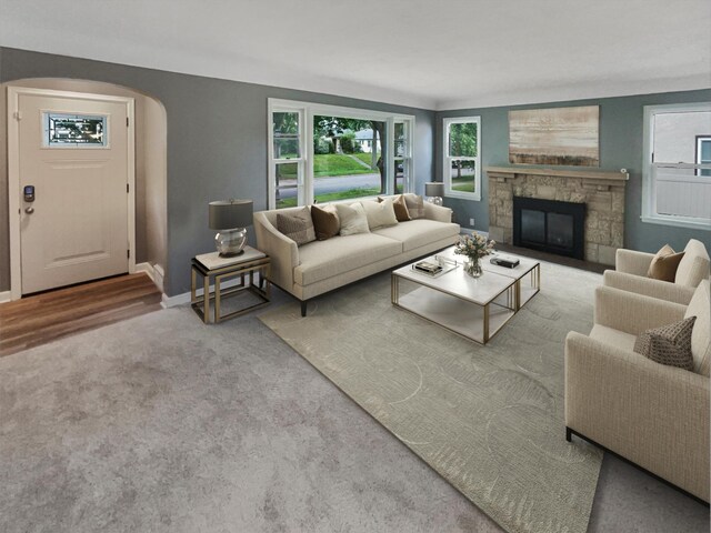 living room featuring hardwood / wood-style floors and a stone fireplace