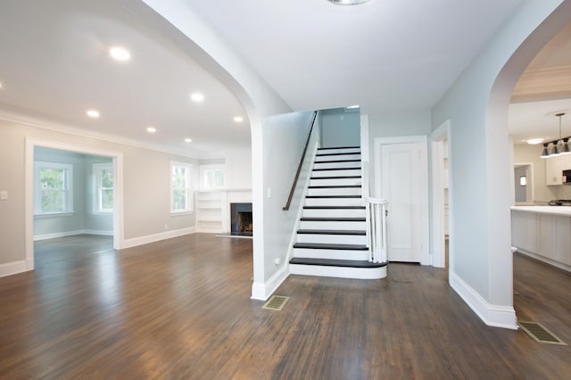 staircase featuring hardwood / wood-style flooring and ornamental molding