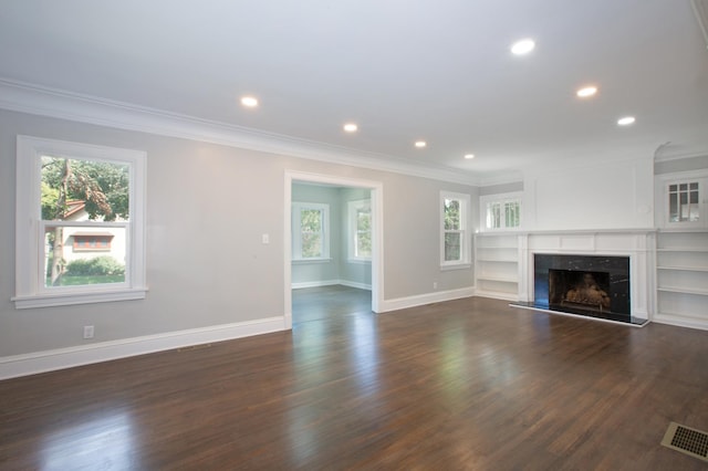 unfurnished living room featuring dark wood-type flooring and crown molding