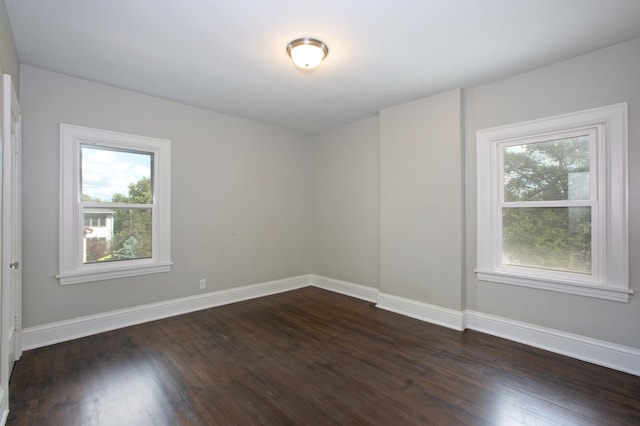 spare room featuring dark hardwood / wood-style flooring