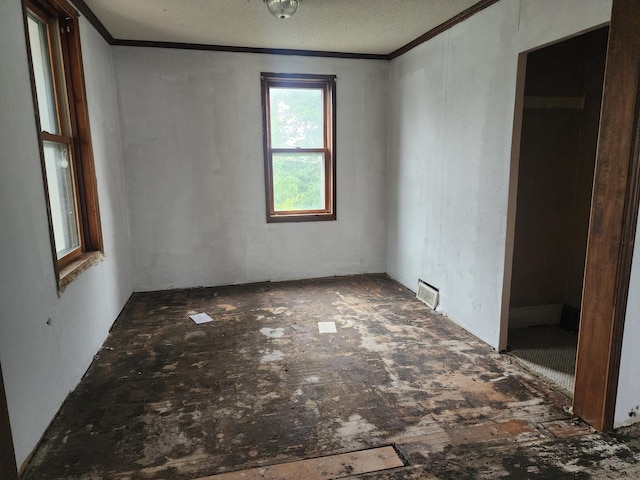 empty room featuring crown molding