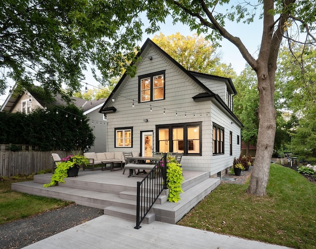 back of house featuring outdoor lounge area and a lawn