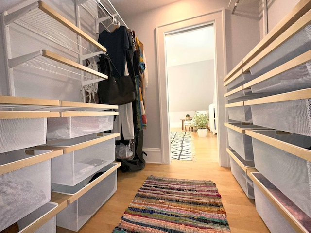 spacious closet with light hardwood / wood-style floors