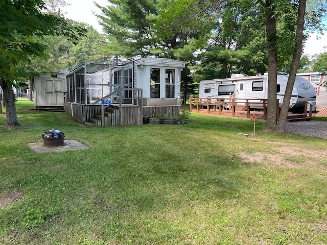 25683 Circle Dr, Garrison Twp, MN 56401 - view of grassy yard featuring a fire pit