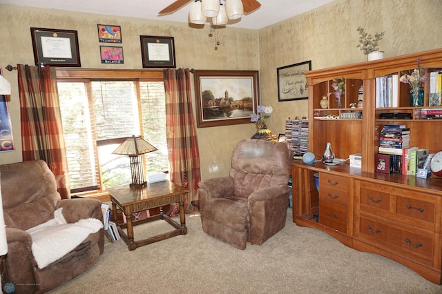 sitting room with carpet and a ceiling fan