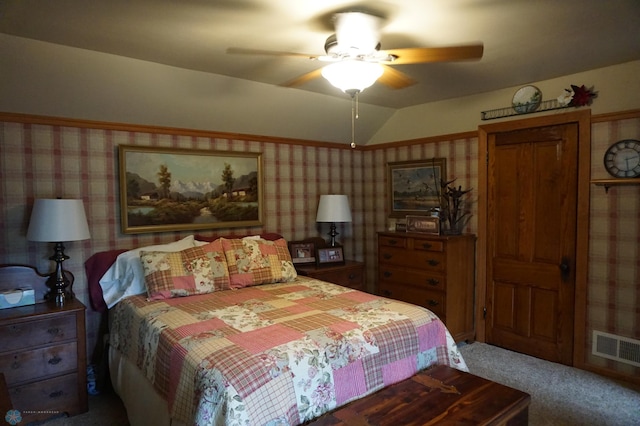 bedroom featuring wallpapered walls, visible vents, lofted ceiling, ceiling fan, and carpet