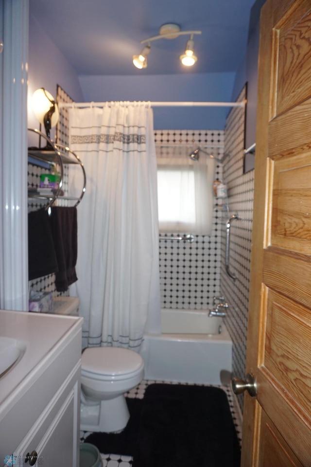 full bath with vanity, shower / bath combination with curtain, and toilet