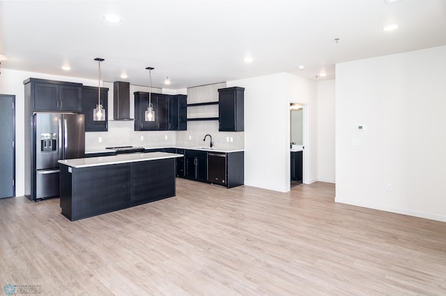 kitchen with light hardwood / wood-style floors, stainless steel fridge with ice dispenser, a center island, and wall chimney range hood