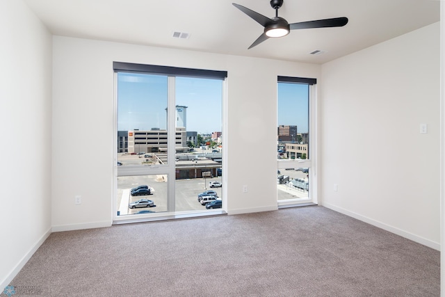 carpeted empty room featuring ceiling fan