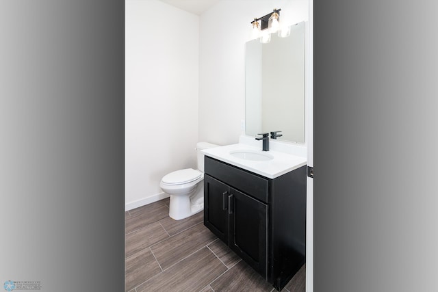 bathroom with toilet and vanity