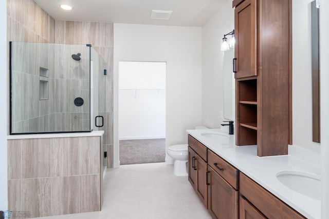 bathroom featuring vanity, tile patterned floors, toilet, and walk in shower