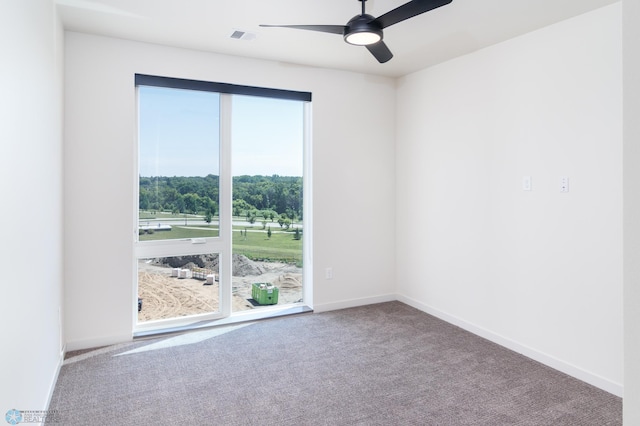 carpeted spare room with ceiling fan