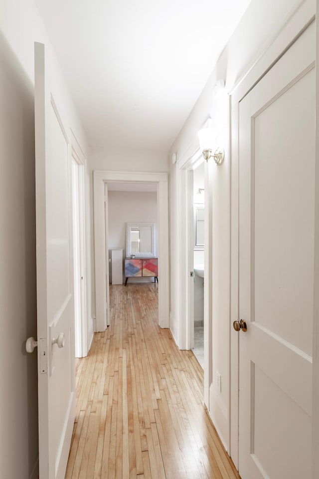 corridor with light hardwood / wood-style floors