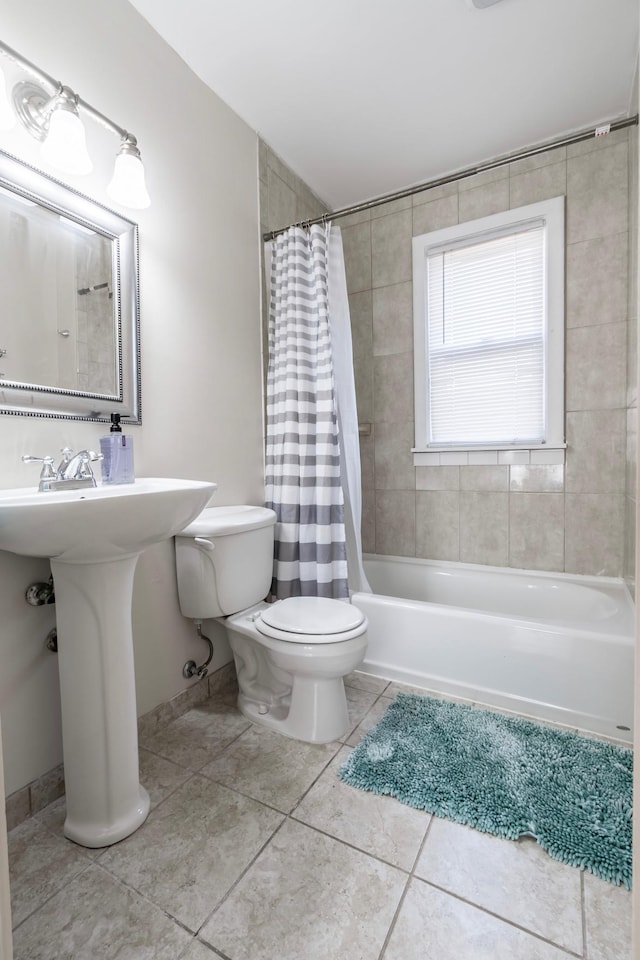 bathroom with toilet, shower / bath combo with shower curtain, and tile patterned floors