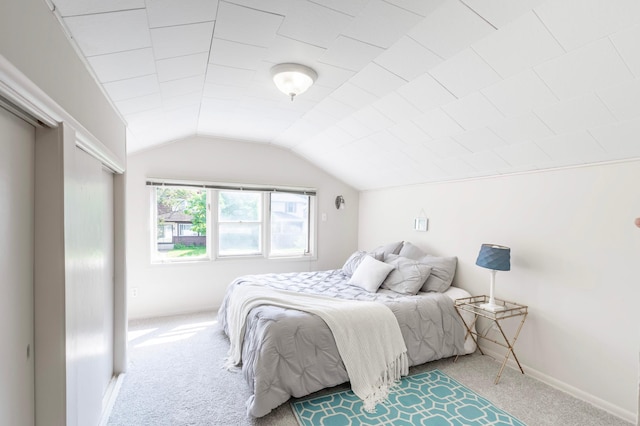 bedroom featuring carpet floors and lofted ceiling