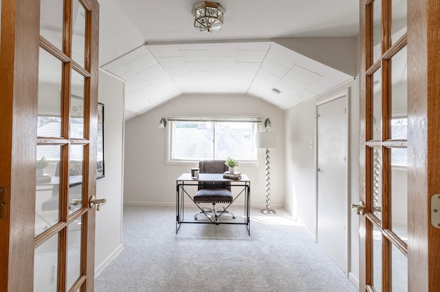 home office with carpet flooring, vaulted ceiling, and french doors