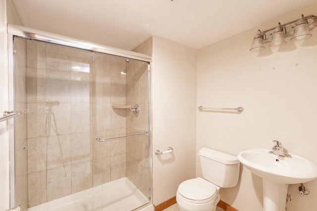 bathroom featuring toilet and an enclosed shower