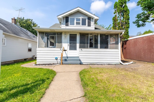 bungalow featuring a sunroom and a front lawn