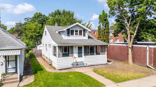 bungalow-style home featuring a front lawn