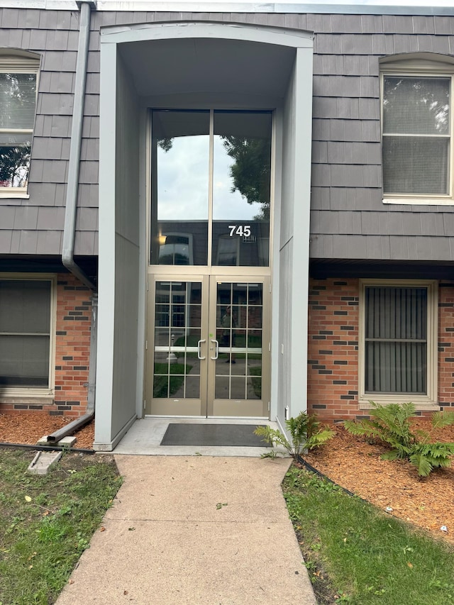 property entrance with french doors and brick siding