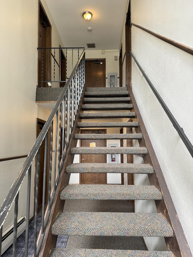 stairs featuring a baseboard radiator