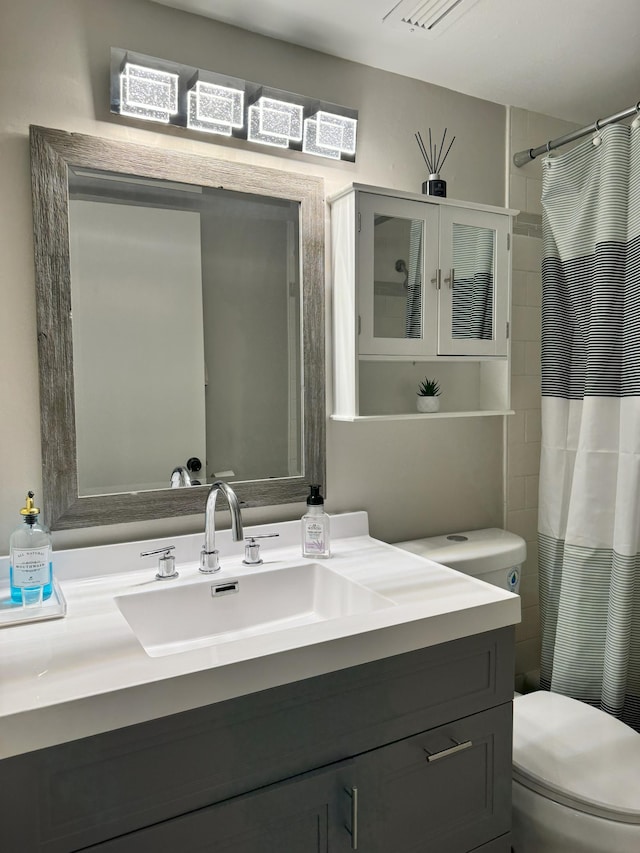 full bathroom with toilet, curtained shower, and vanity