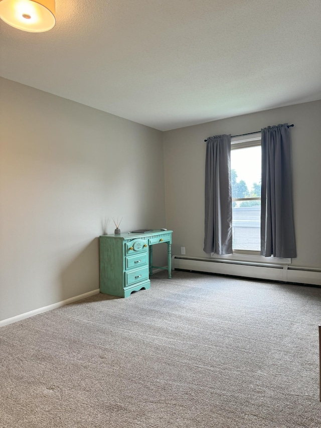 carpeted spare room featuring a baseboard radiator, baseboards, and a textured ceiling