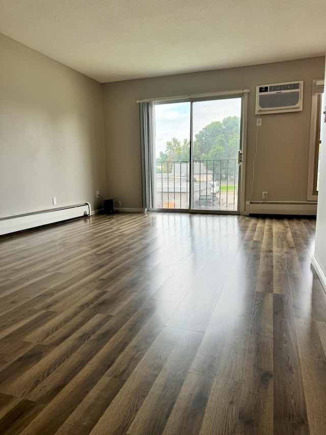 unfurnished living room featuring a baseboard heating unit, baseboards, a wall mounted AC, baseboard heating, and dark wood finished floors