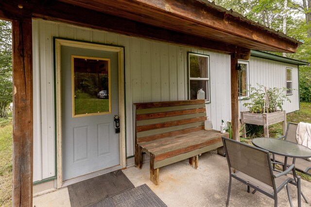 entrance to property featuring a patio area and outdoor dining area