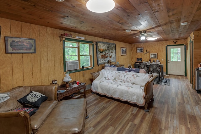 living area with wood ceiling, ceiling fan, and wood finished floors