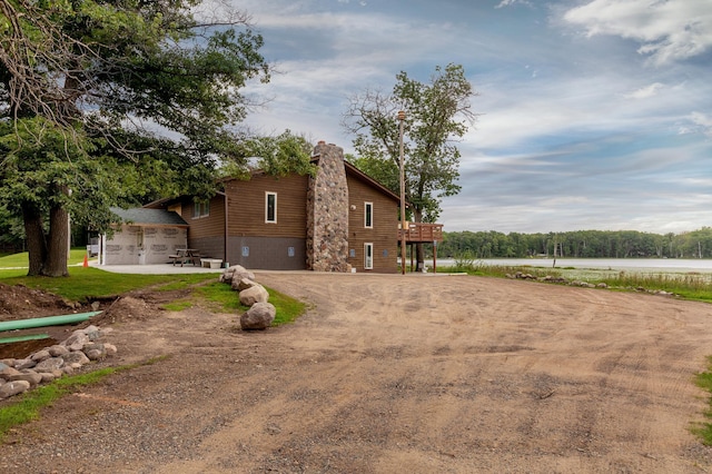 view of home's exterior with driveway and a chimney