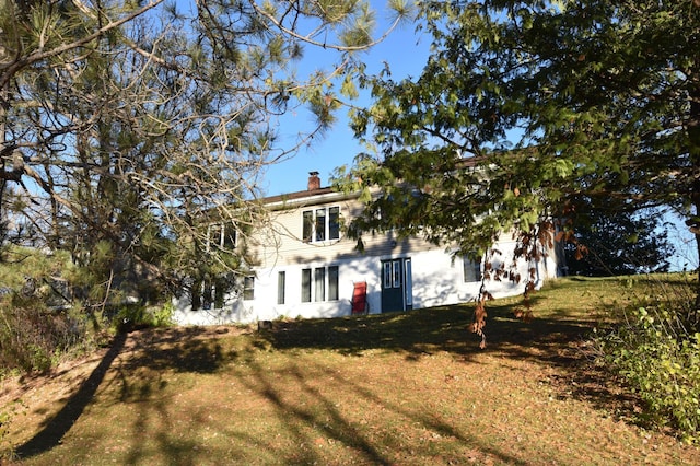 205 2nd Ave SE, Baudette, MN 56623 - back of house with a chimney and a yard