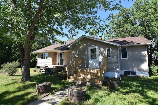 205 2nd Ave SE, Baudette, MN 56623 - view of front of house featuring a front lawn and a chimney