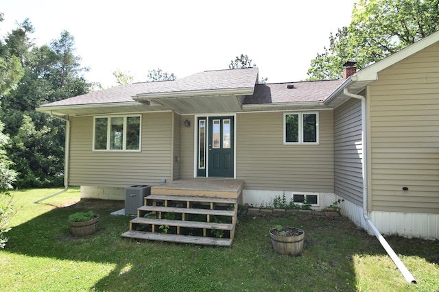 205 2nd Ave SE, Baudette, MN 56623 - back of property with a lawn and a chimney