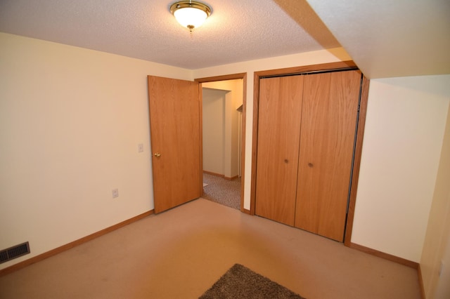 205 2nd Ave SE, Baudette, MN 56623 - unfurnished bedroom with a closet, carpet, and a textured ceiling