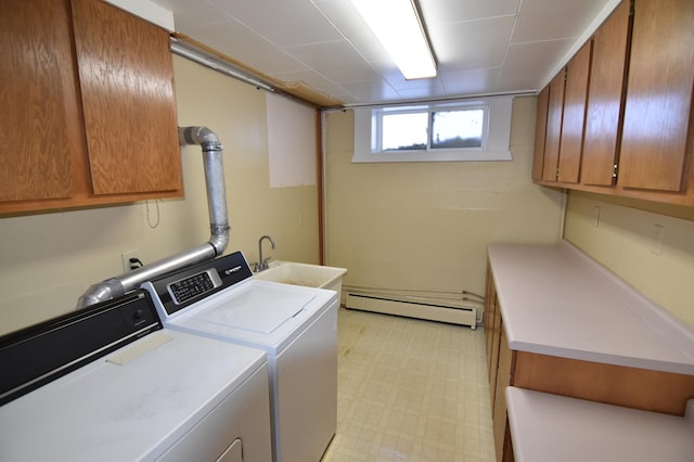 205 2nd Ave SE, Baudette, MN 56623 - washroom featuring a baseboard radiator, cabinet space, washing machine and dryer, and light flooring