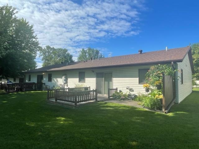 rear view of house featuring a lawn