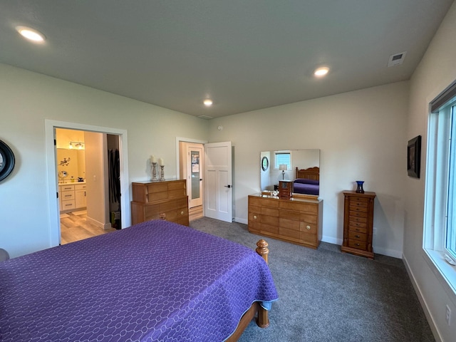 carpeted bedroom with ensuite bath