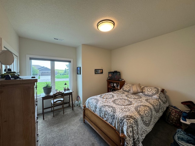 carpeted bedroom with a textured ceiling